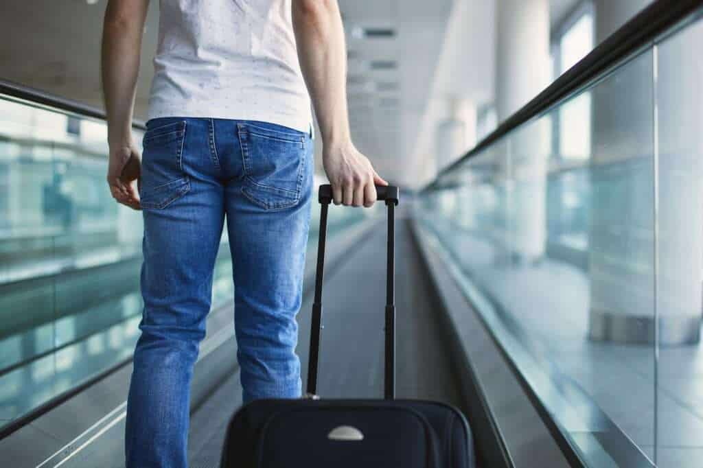 Man walking with suitcase at airport terminal