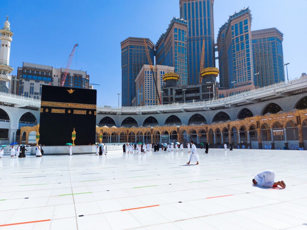 Pilgrims in Kaaba in Macca al Haram - umrah Covid 19 coronavirus restrictions face mask